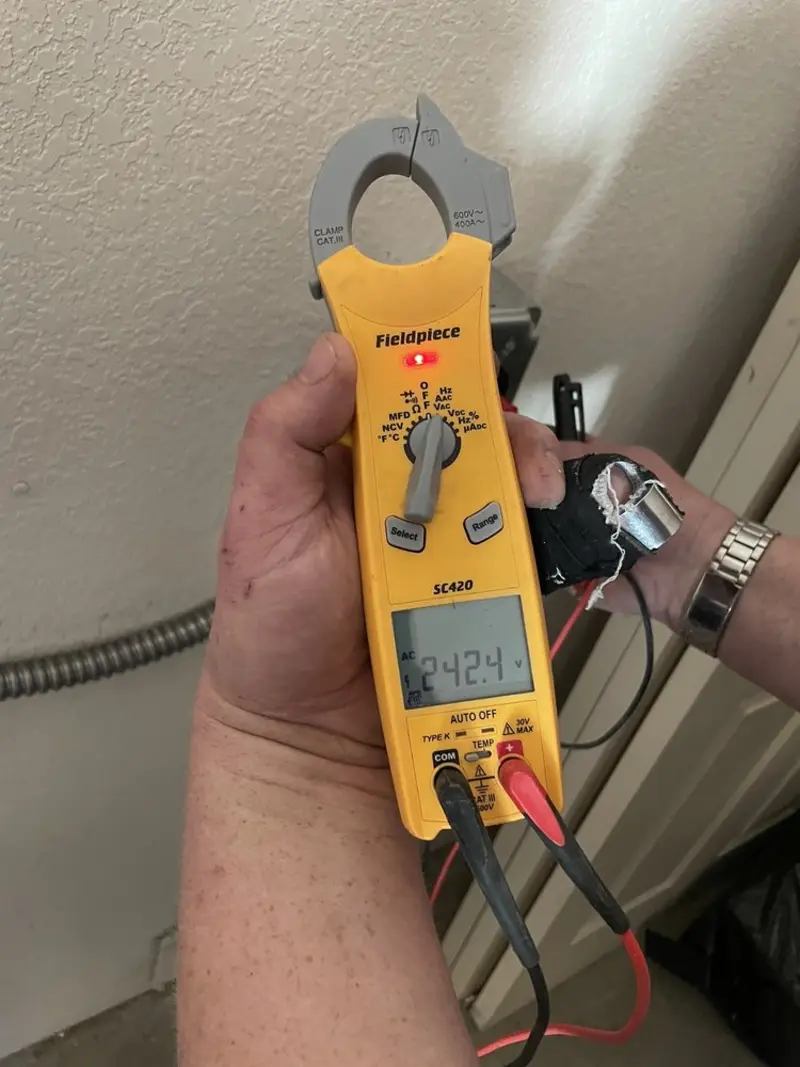 Voltage testing with clamp meter during Circuit Breaker Repair in Carey